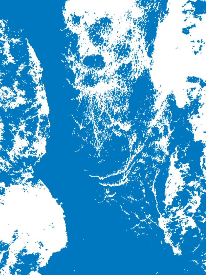Blue water gathering around pale islands and channels.
